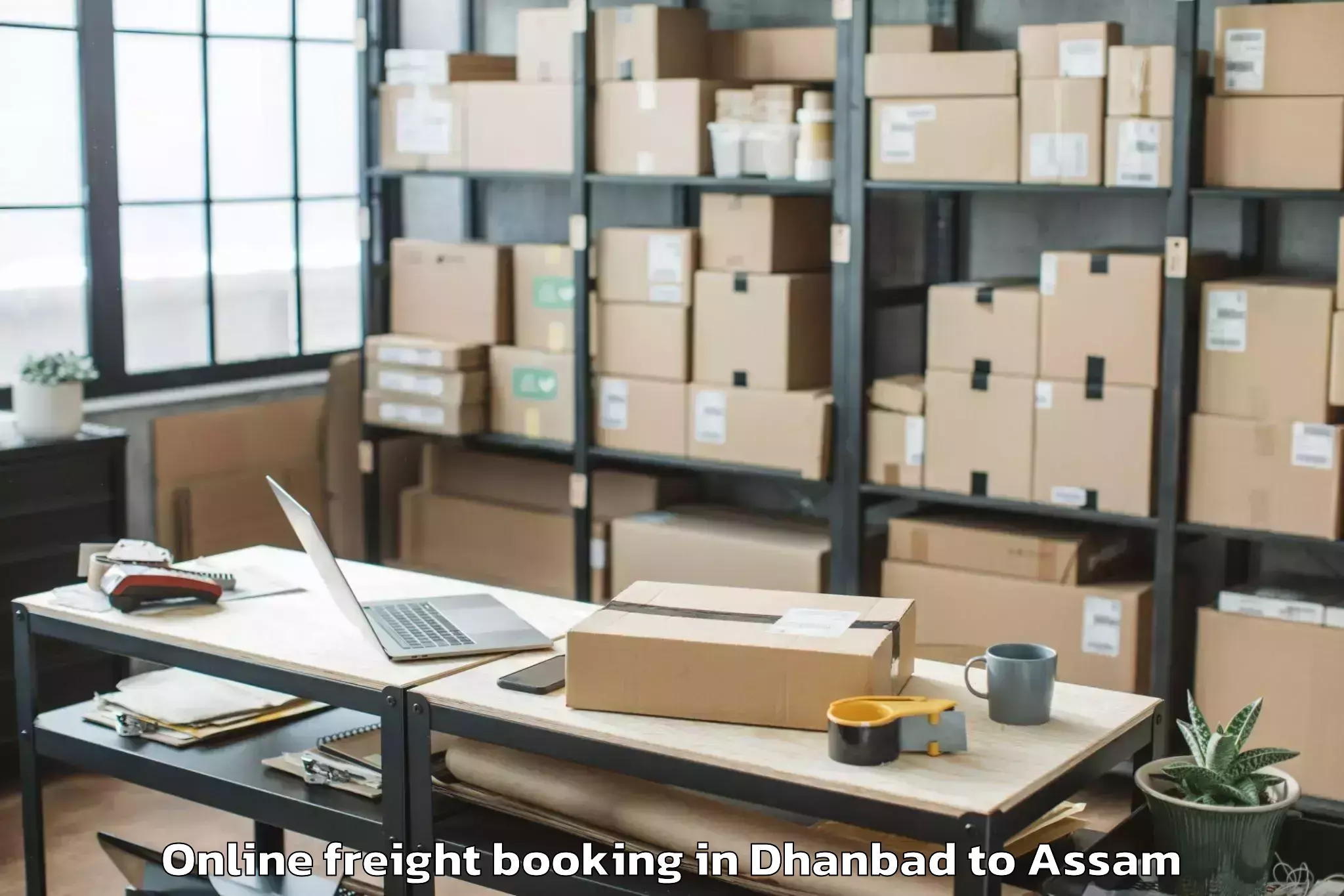 Book Dhanbad to Banekuchi Online Freight Booking